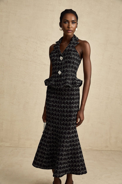 Woman wearing black checked tweed vest top and matching skirt set named Axelle