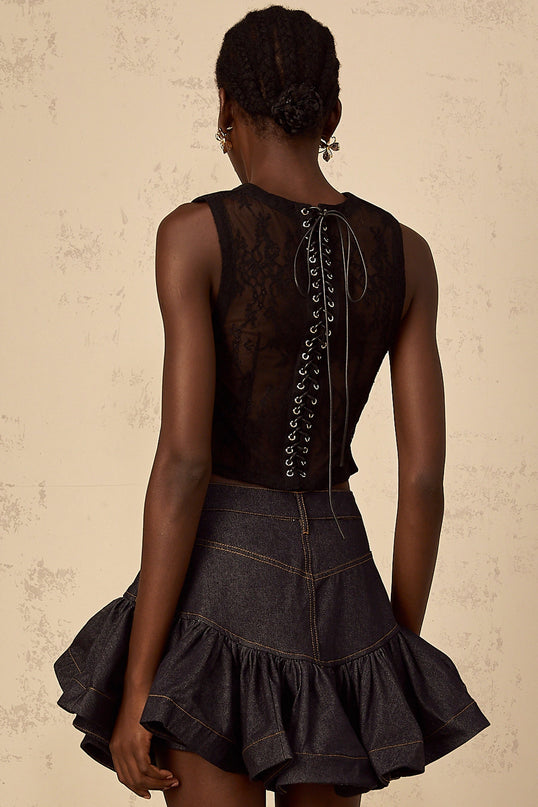 Woman wearing black cropped top with lace panel detail