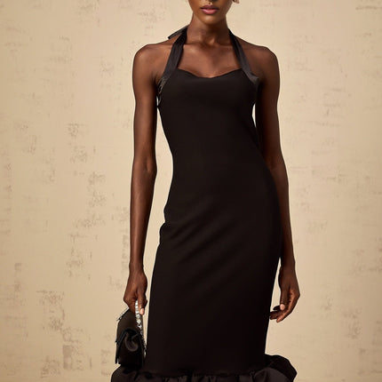 Woman wearing black halterneck midi dress with bubble hem