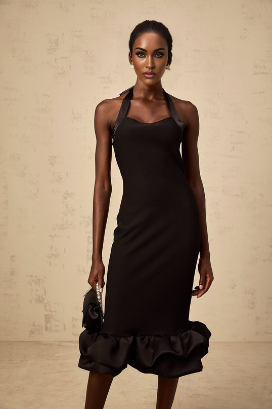 Woman wearing black halterneck midi dress with bubble hem