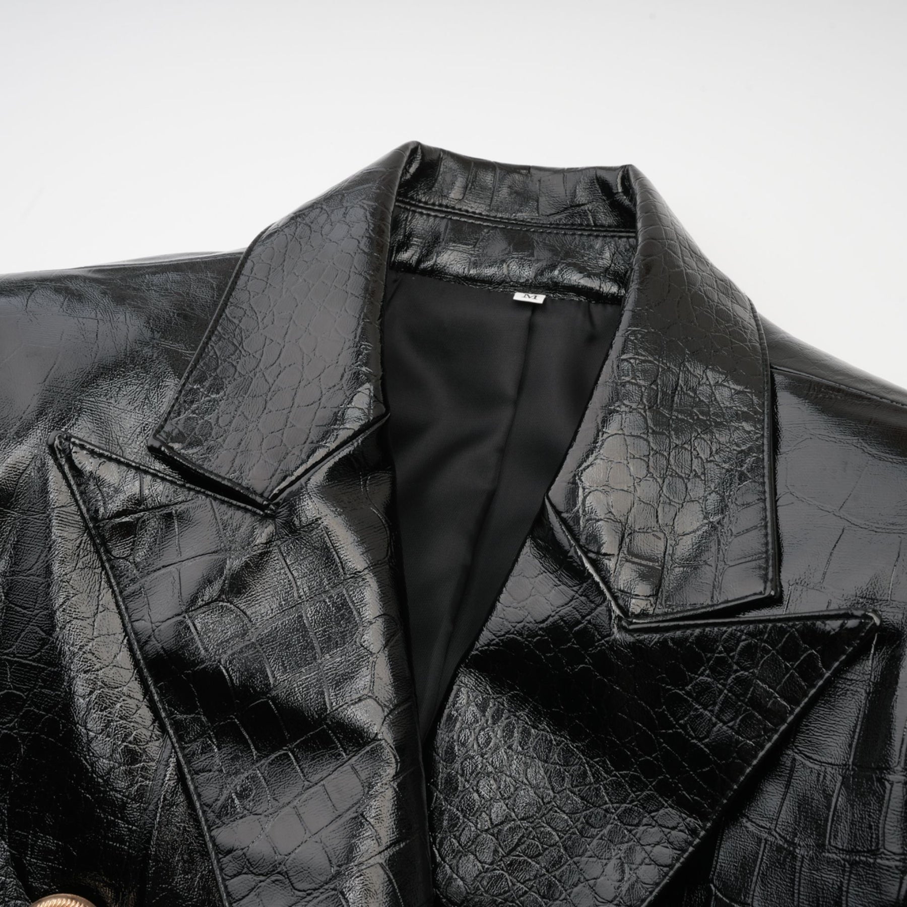 Woman wearing black leather jacket with cinched waist and zipper closure