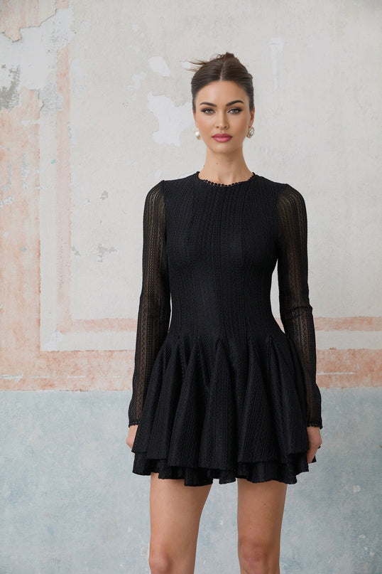 Woman wearing black mini dress with puff sleeves and pointelle knit pattern