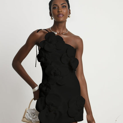 Woman wearing black offshoulder mini dress with floral pattern