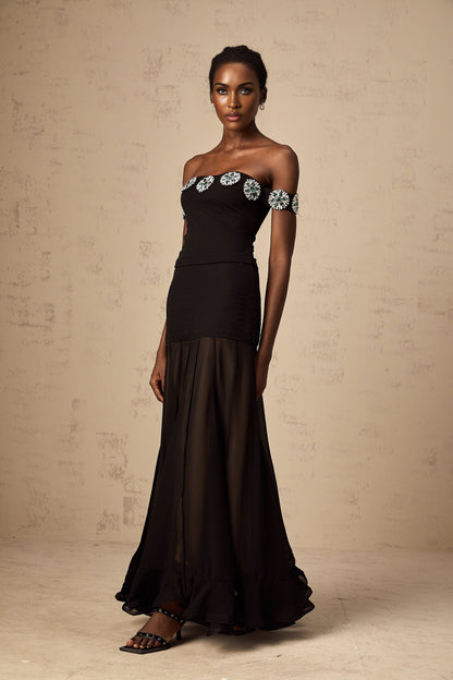 Woman wearing black offshoulder top with embellishments