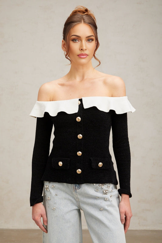 Woman wearing black offshoulder top with ruffled design