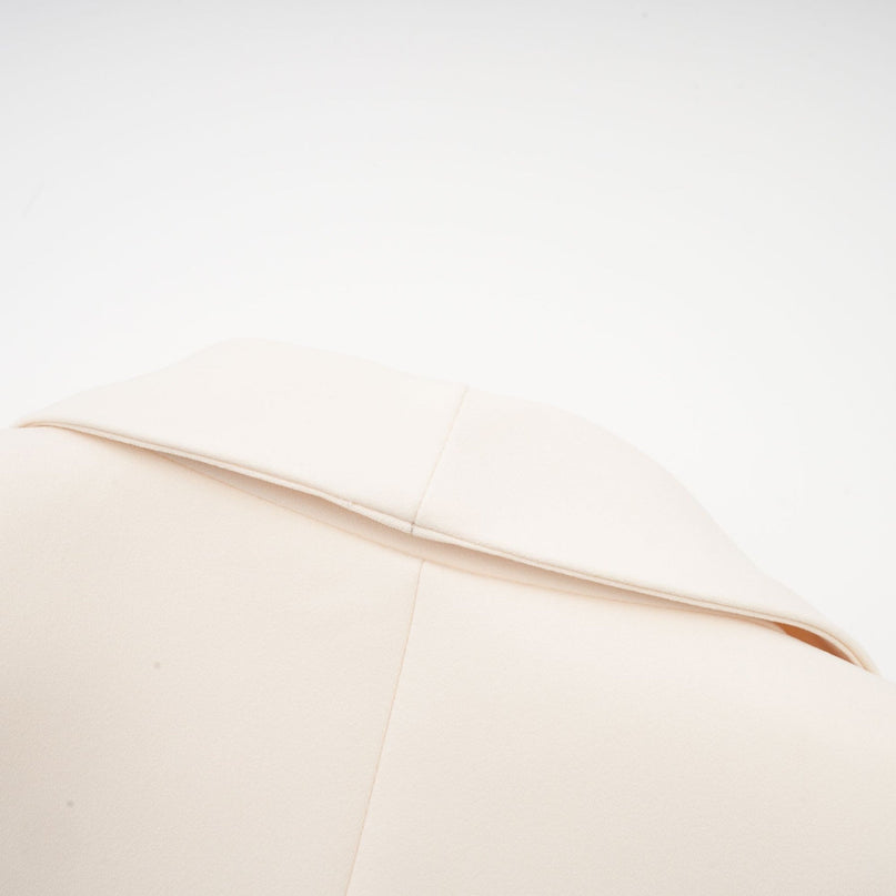 Woman wearing black sequined blazer dress with embellishments and long sleeves