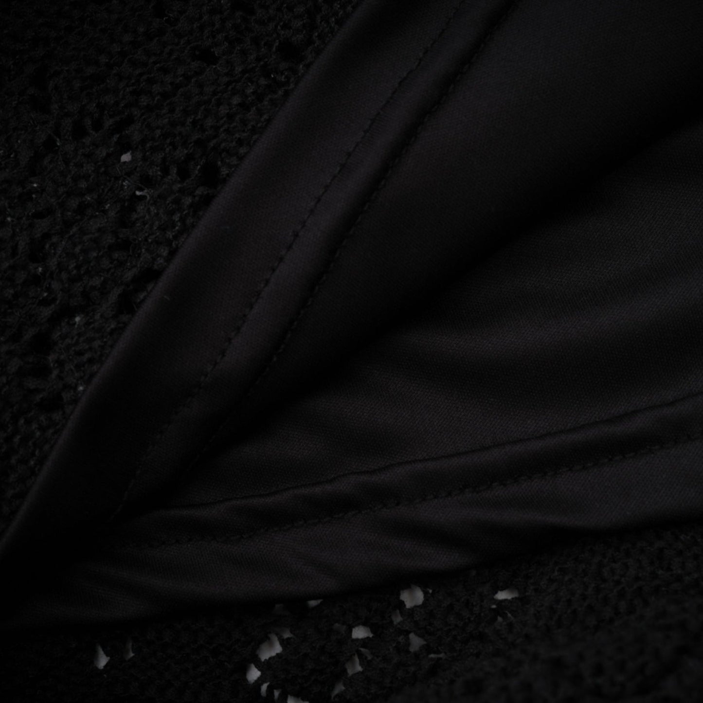 Woman wearing black sequined cardigan and matching skirt set with crochet knit pattern
