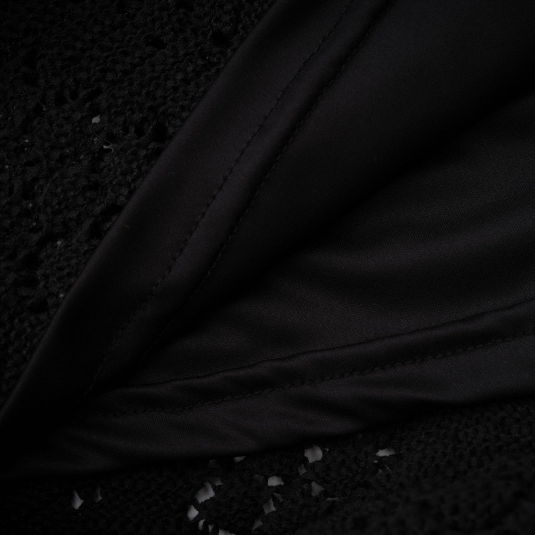 Woman wearing black sequined cardigan and matching skirt set with crochet knit pattern