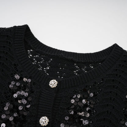 Woman wearing black sequined cardigan and matching skirt set with crochet knit pattern