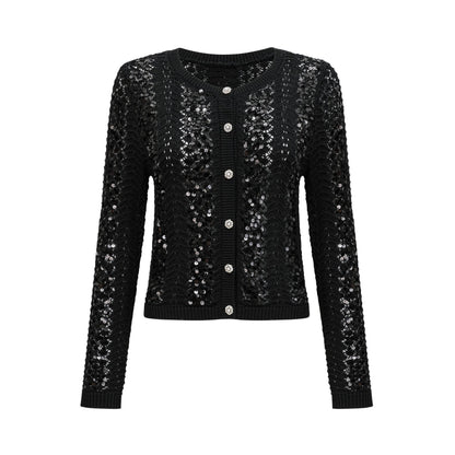 Woman wearing black sequined crochet knit cardigan and matching skirt set