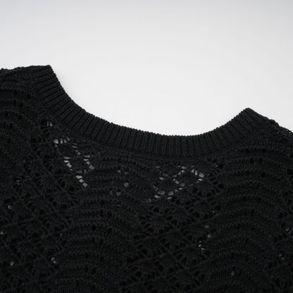 Woman wearing black sequined crochet knit cardigan and matching skirt set