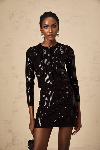 Woman wearing black sequined ribbed knit cardigan and matching skirt set shimmering outfit for evening wear