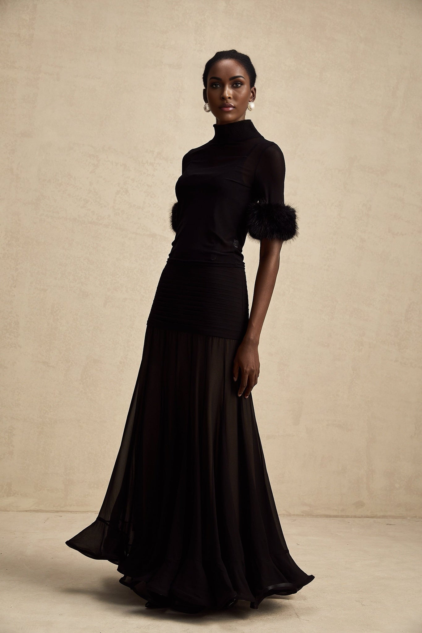 Woman wearing black sleeveless faux fur top with tulle overlay