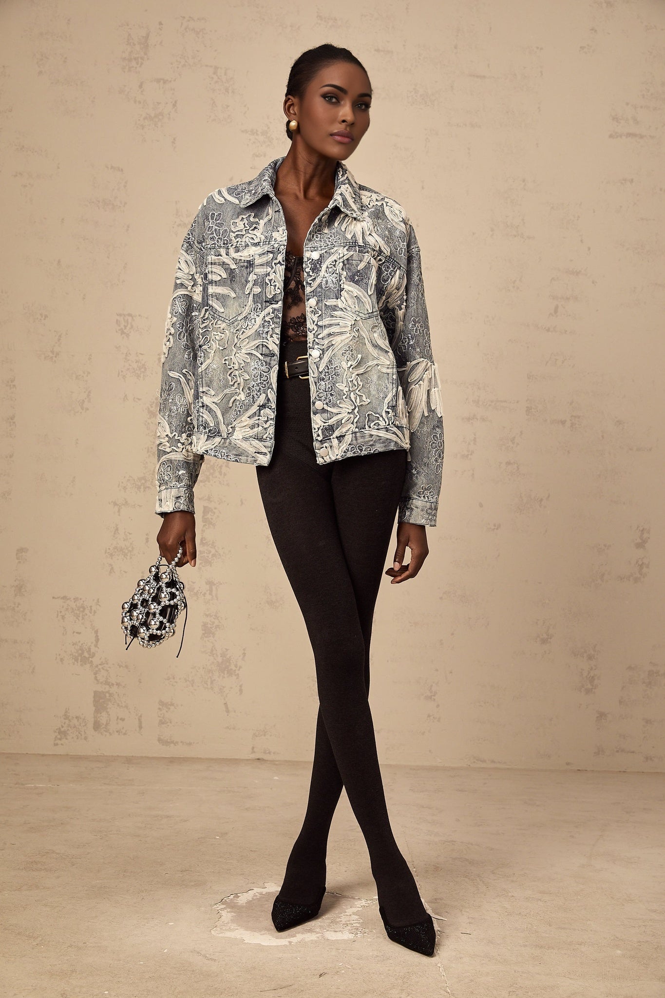 Woman wearing blue denim jacket with sequined flower embroidery design