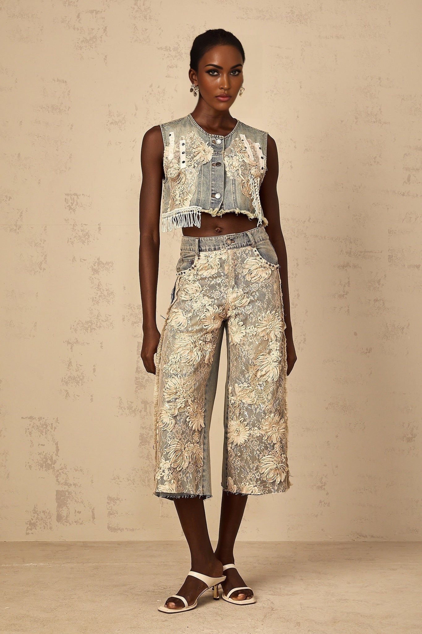 Woman wearing blue denim jeans with floral lace panels on the sides