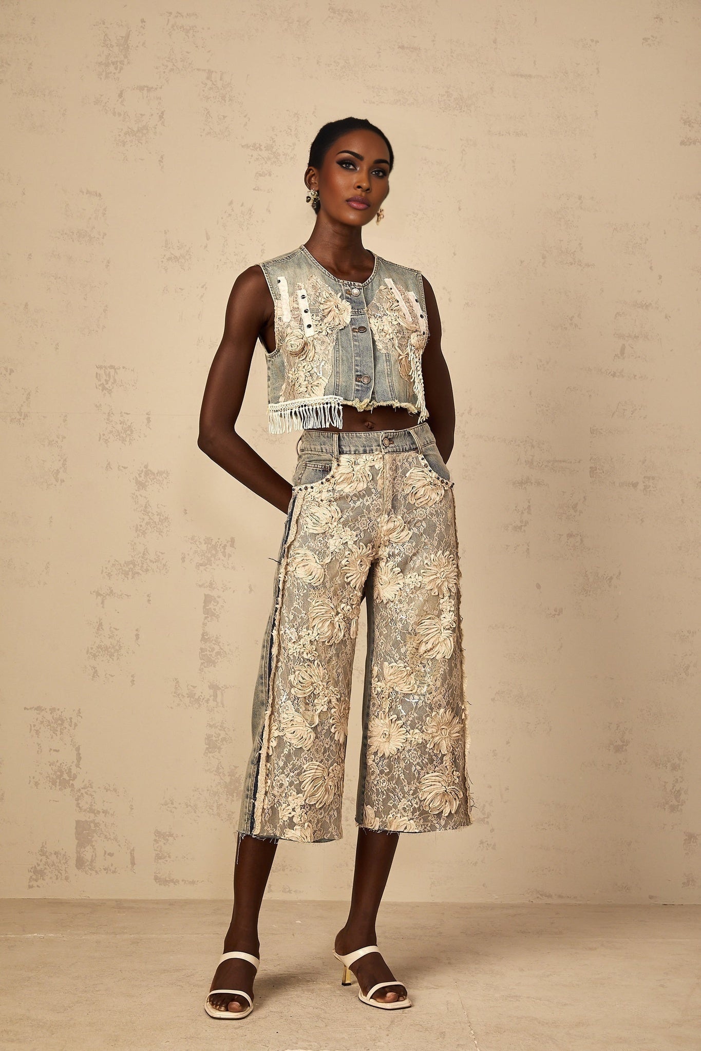 Woman wearing blue denim jeans with floral lace panels on the sides