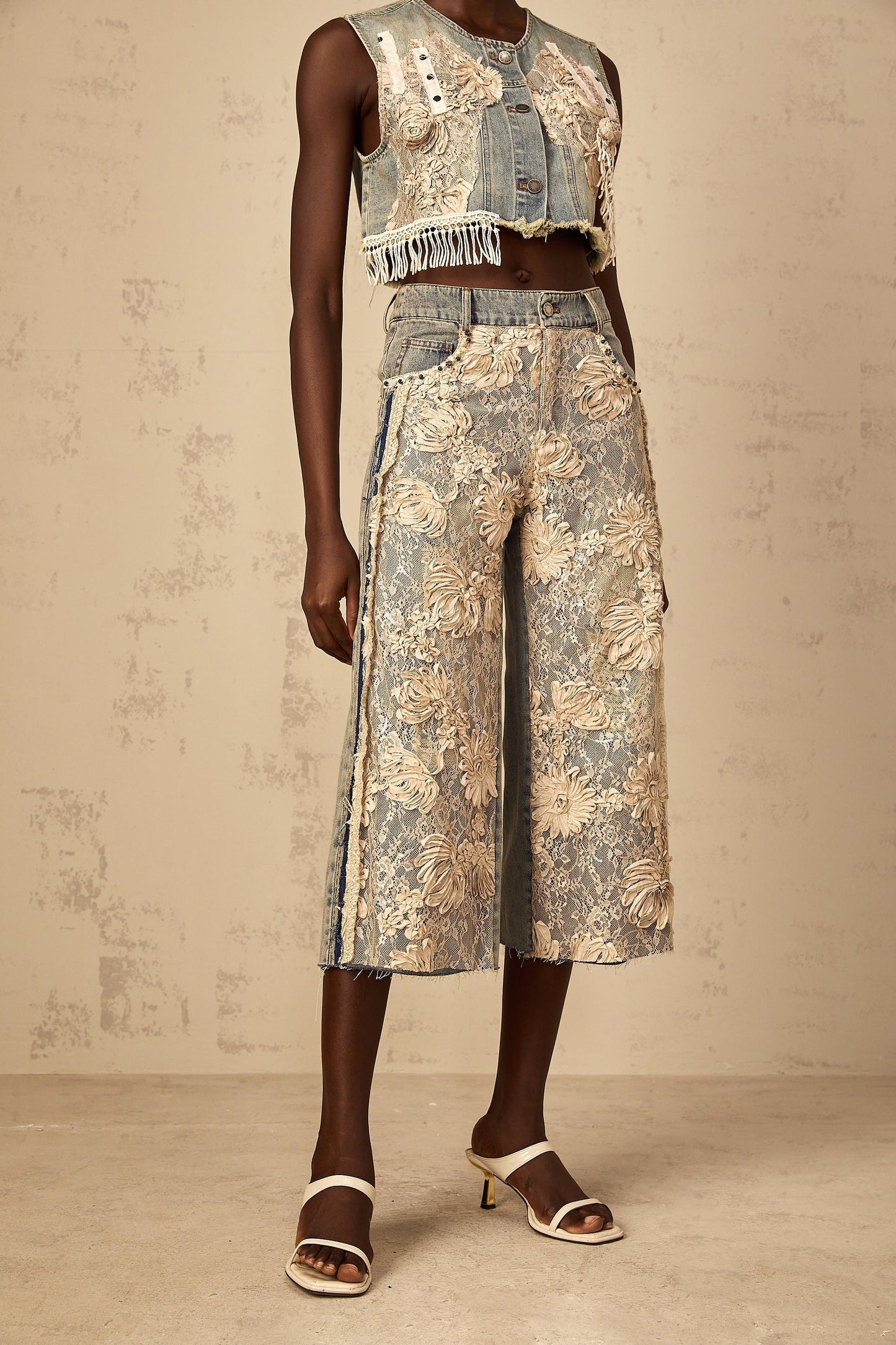 Woman wearing blue denim jeans with floral lace panels on the sides