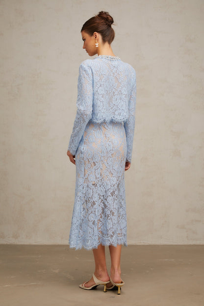 Woman wearing blue floral lace matching set consisting of a top and skirt Ariane design