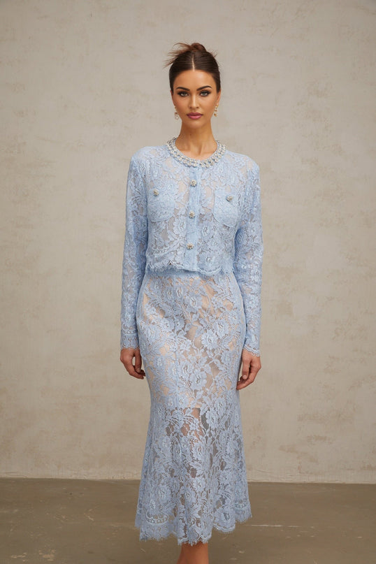 Woman wearing blue floral lace matching top and skirt set