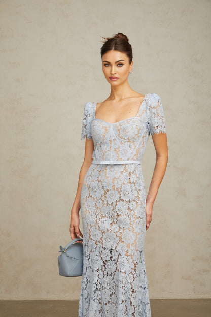 Woman wearing blue floral lace midi dress with boned bodice and fitted silhouette