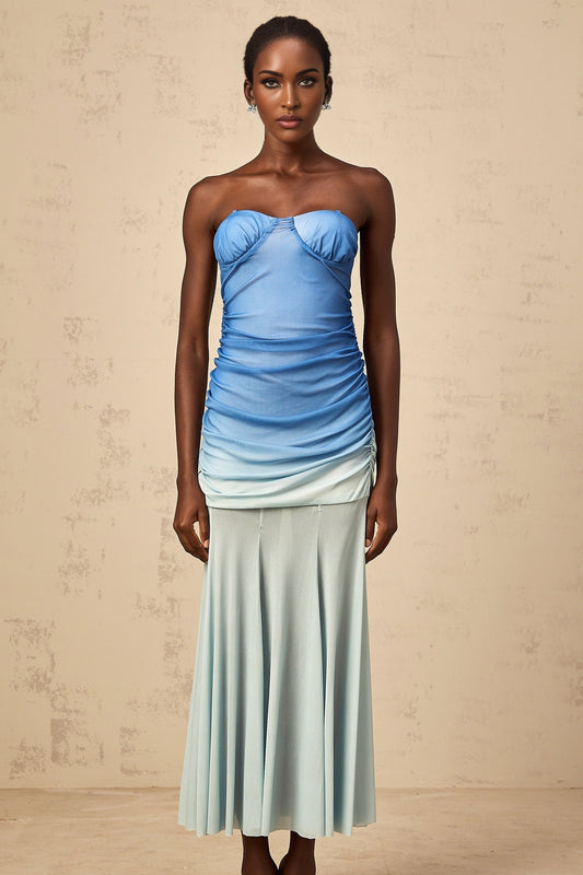 Woman wearing blue gradient mesh midi dress with ombre effect fading from dark to light blue