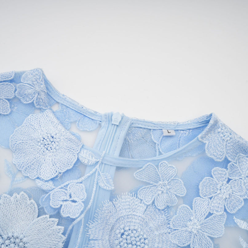 Woman wearing blue midi dress with floral applique details