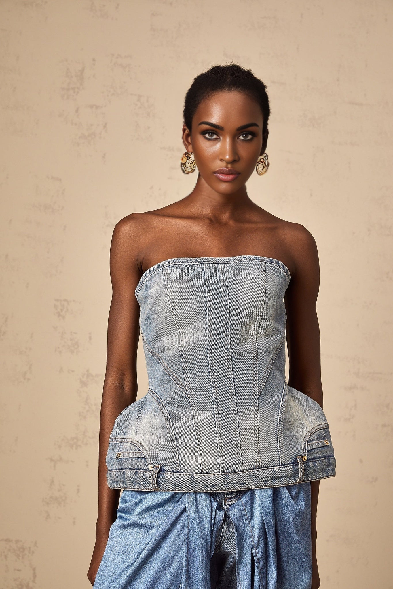 Woman wearing blue off shoulder denim top with relaxed fit