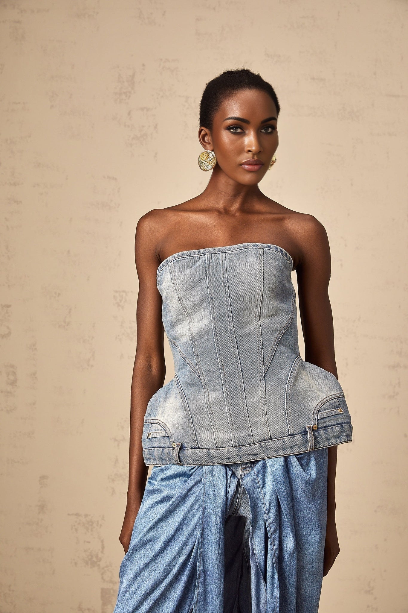 Woman wearing blue off shoulder denim top with short sleeves and relaxed fit