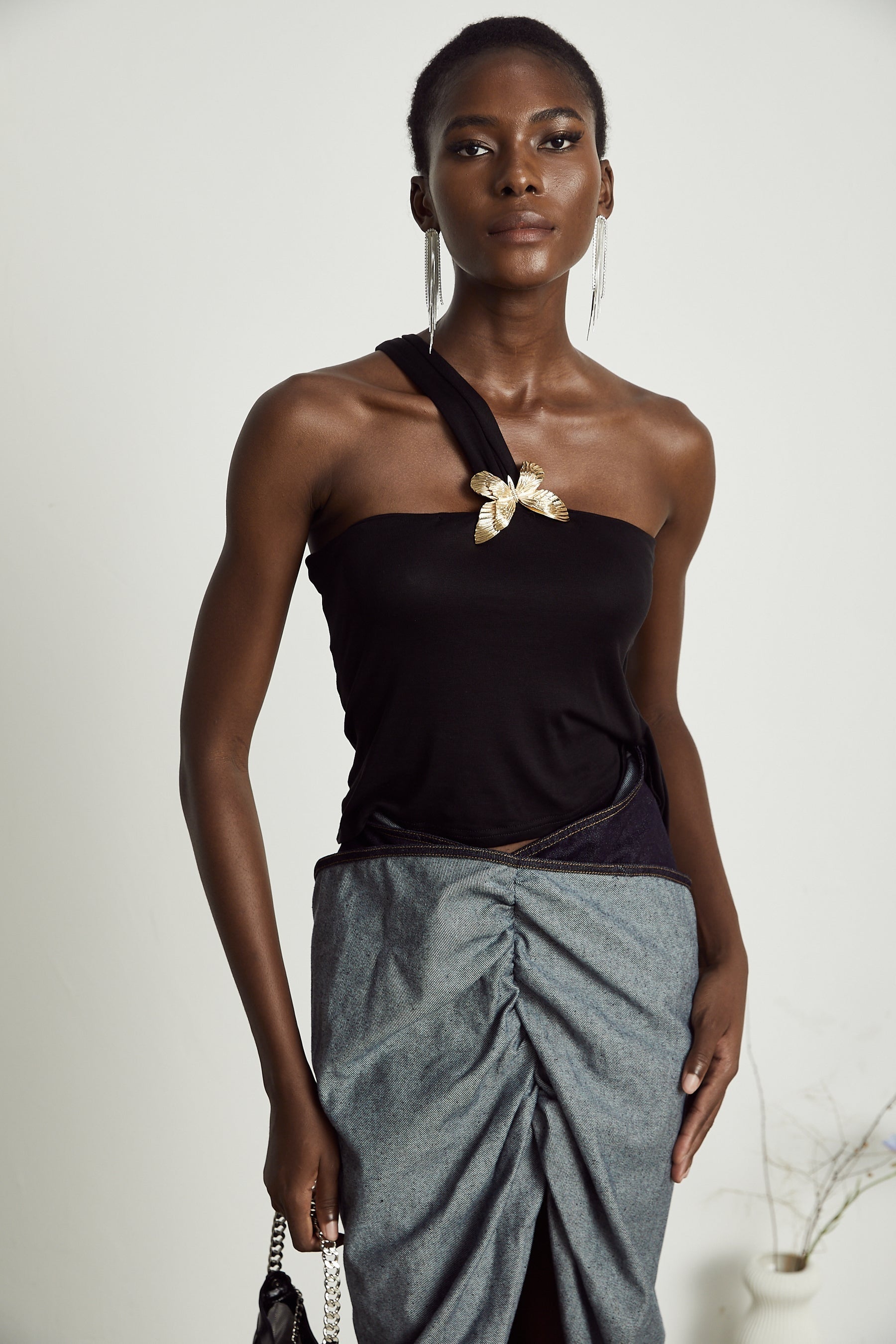 Woman wearing blue offshoulder top with ruffled sleeve