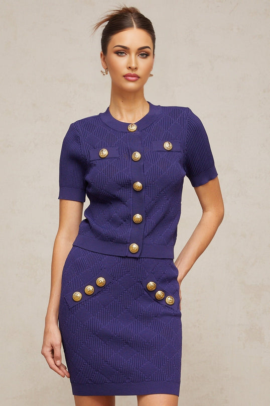 Woman wearing blue plaid knit top and matching skirt set