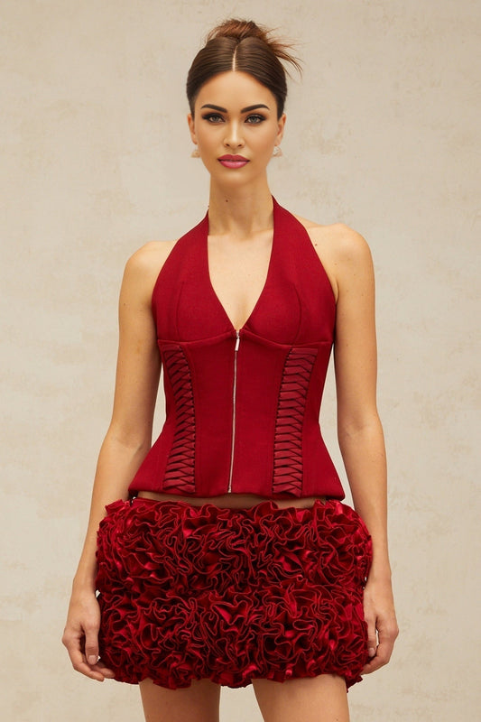 Woman wearing bright red halterneck top with laceup front detail