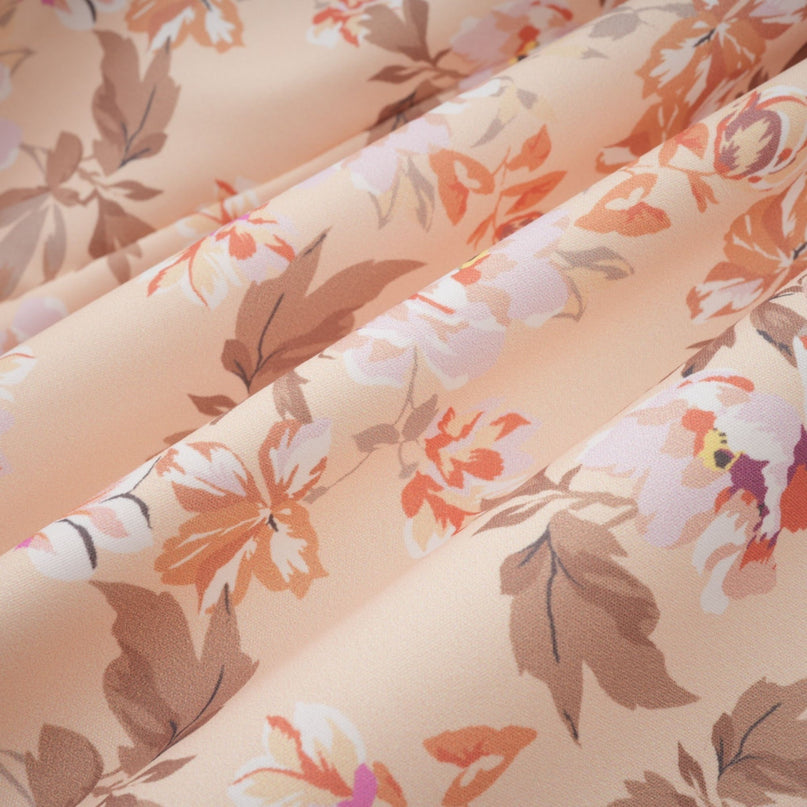 Woman wearing bright yellow midi dress with floral print and button details