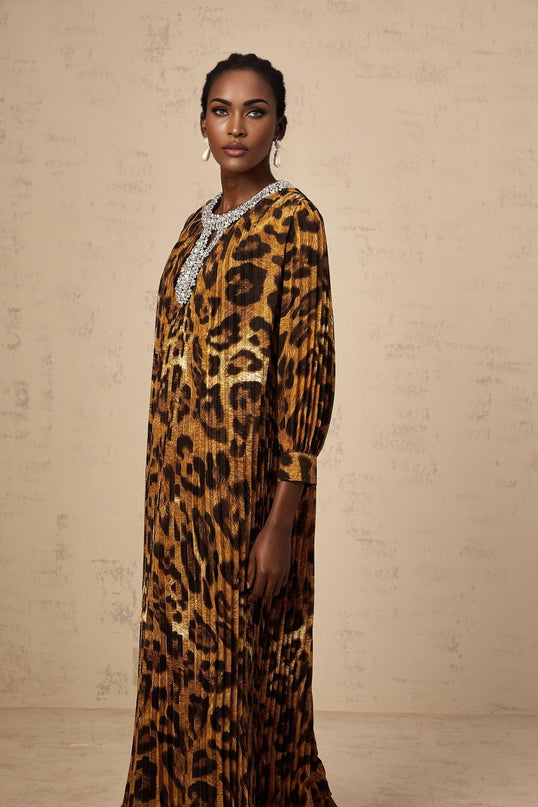 Woman wearing brown leopard print midi dress with embellishments and long sleeves
