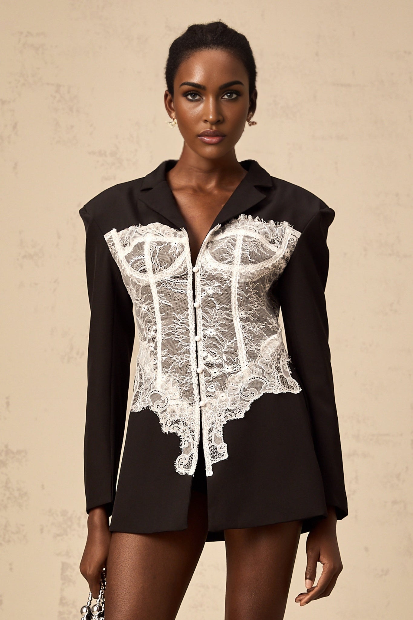 Woman wearing colorblocked blazer with lace panels in contrasting colors