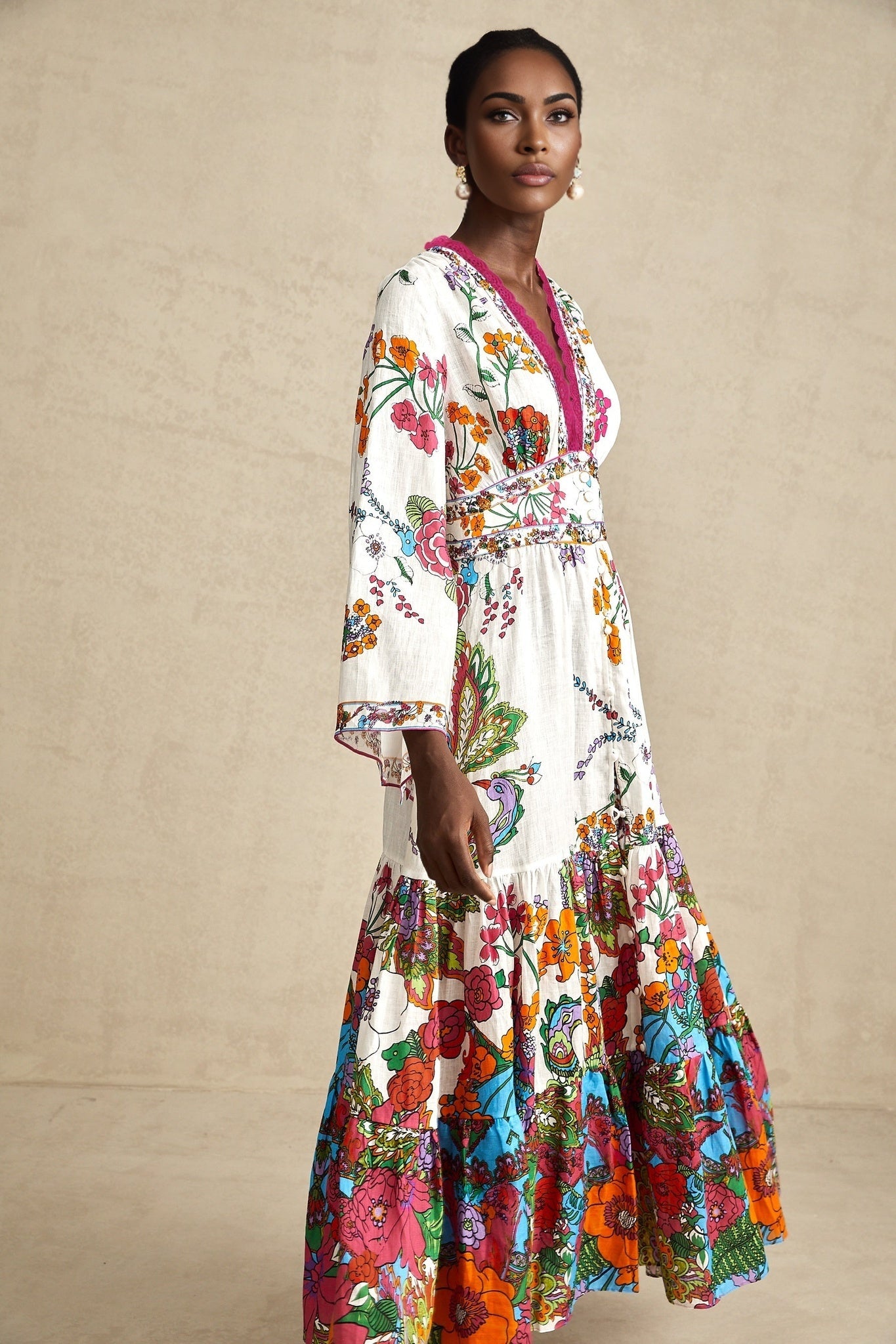 Woman wearing floral print midi dress with Vneck and flowing skirt in soft pastel colors