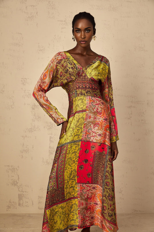 Woman wearing green floral print midi dress with flared skirt and short sleeves standing in casual pose