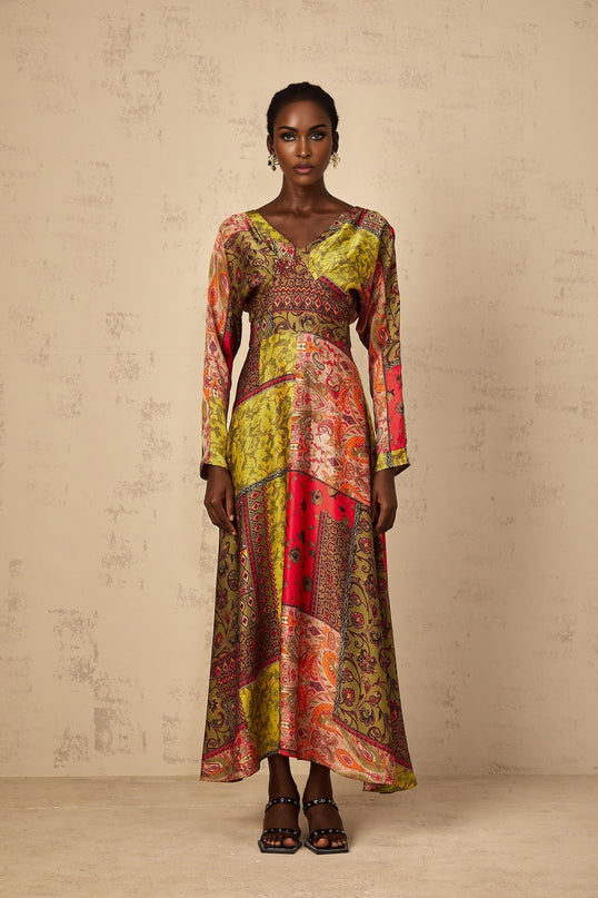 Woman wearing green floral print midi dress with flared skirt and short sleeves