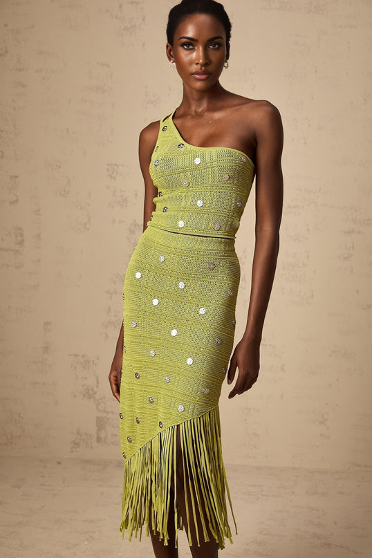 Woman wearing green knit matching set with embellished top and skirt called Annette