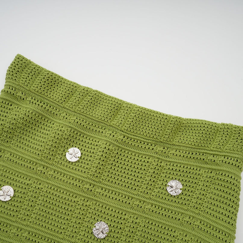 Woman wearing green knit top and skirt set with embellishments Annette matching outfit