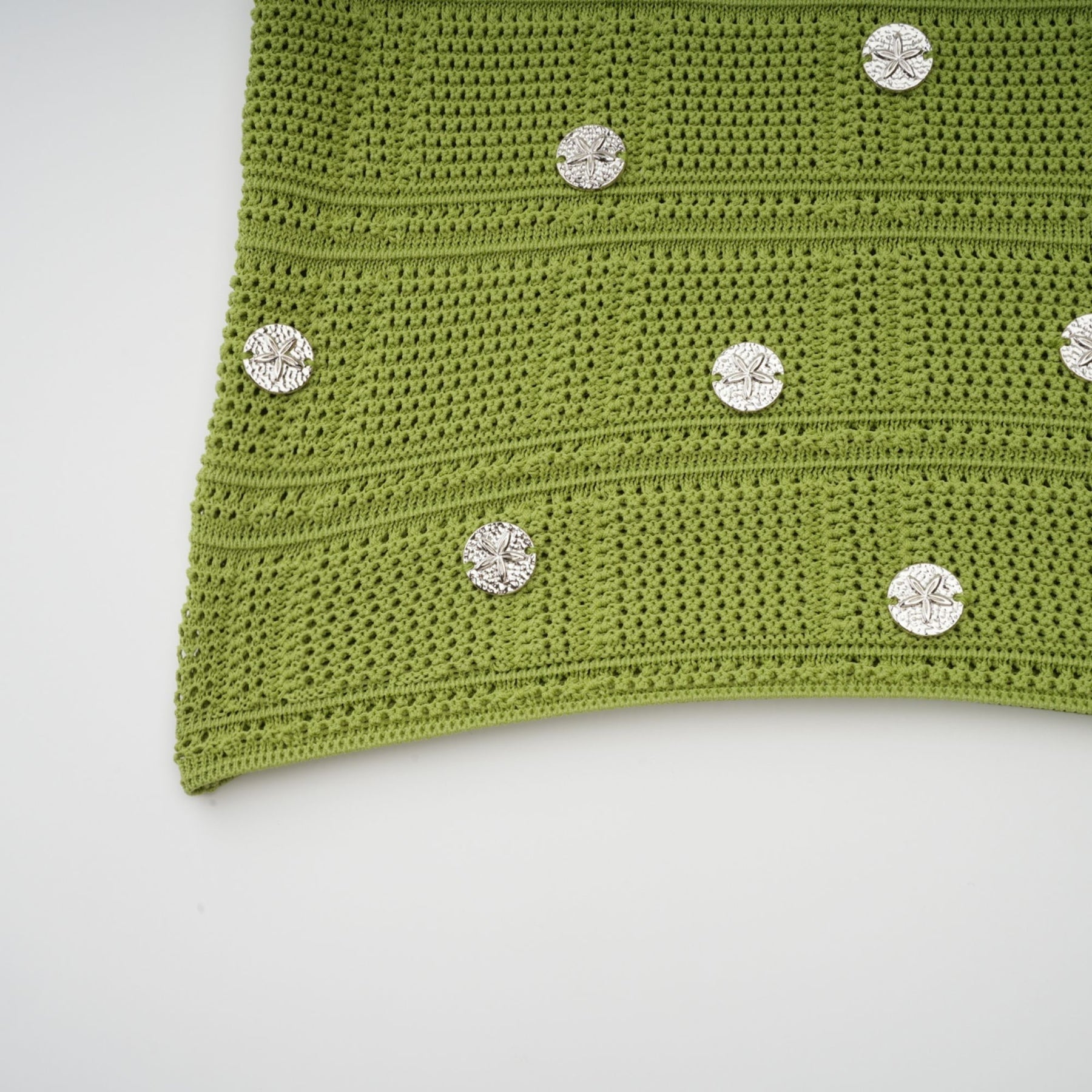 Woman wearing green knit top and skirt set with embellishments Annette matching outfit