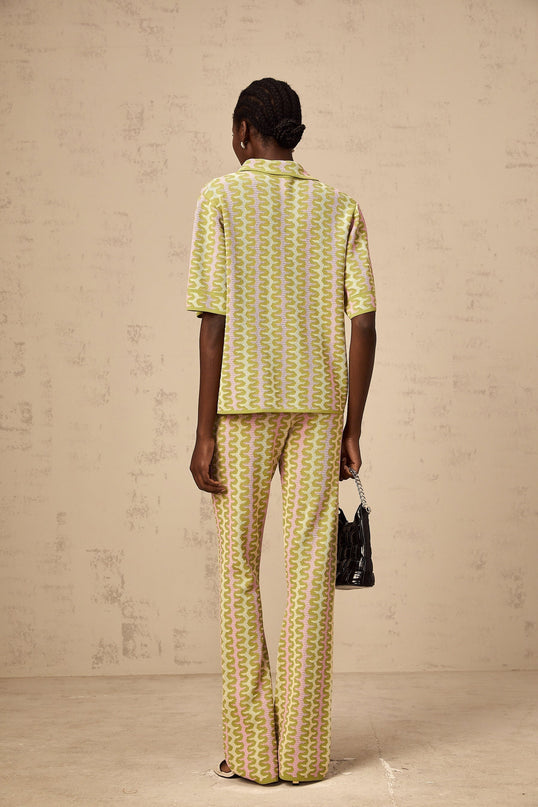 Woman wearing green knitted top and matching trousers color block design casual loungewear set