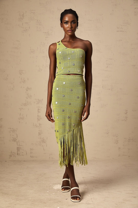 Woman wearing green knitted top and skirt set with embellishments Annette style matching outfit