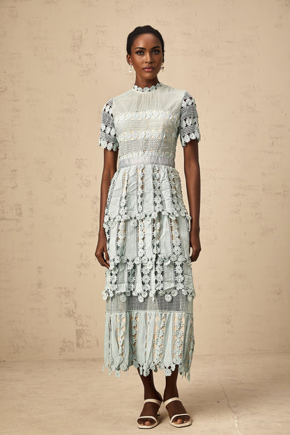Woman wearing green midi dress with floral embroidery pattern