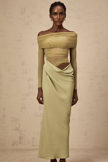Woman wearing green offshoulder midi dress with semisheer fabric standing in relaxed pose