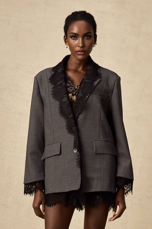 Woman wearing grey blazer with lace panel details