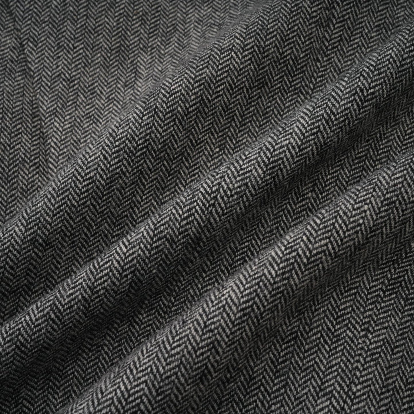 Woman wearing grey herringbone pattern matching top and shorts set
