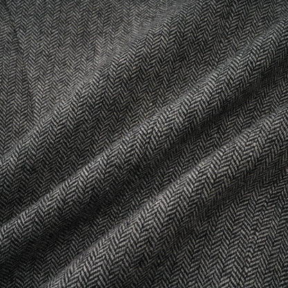 Woman wearing grey herringbone pattern matching top and shorts set