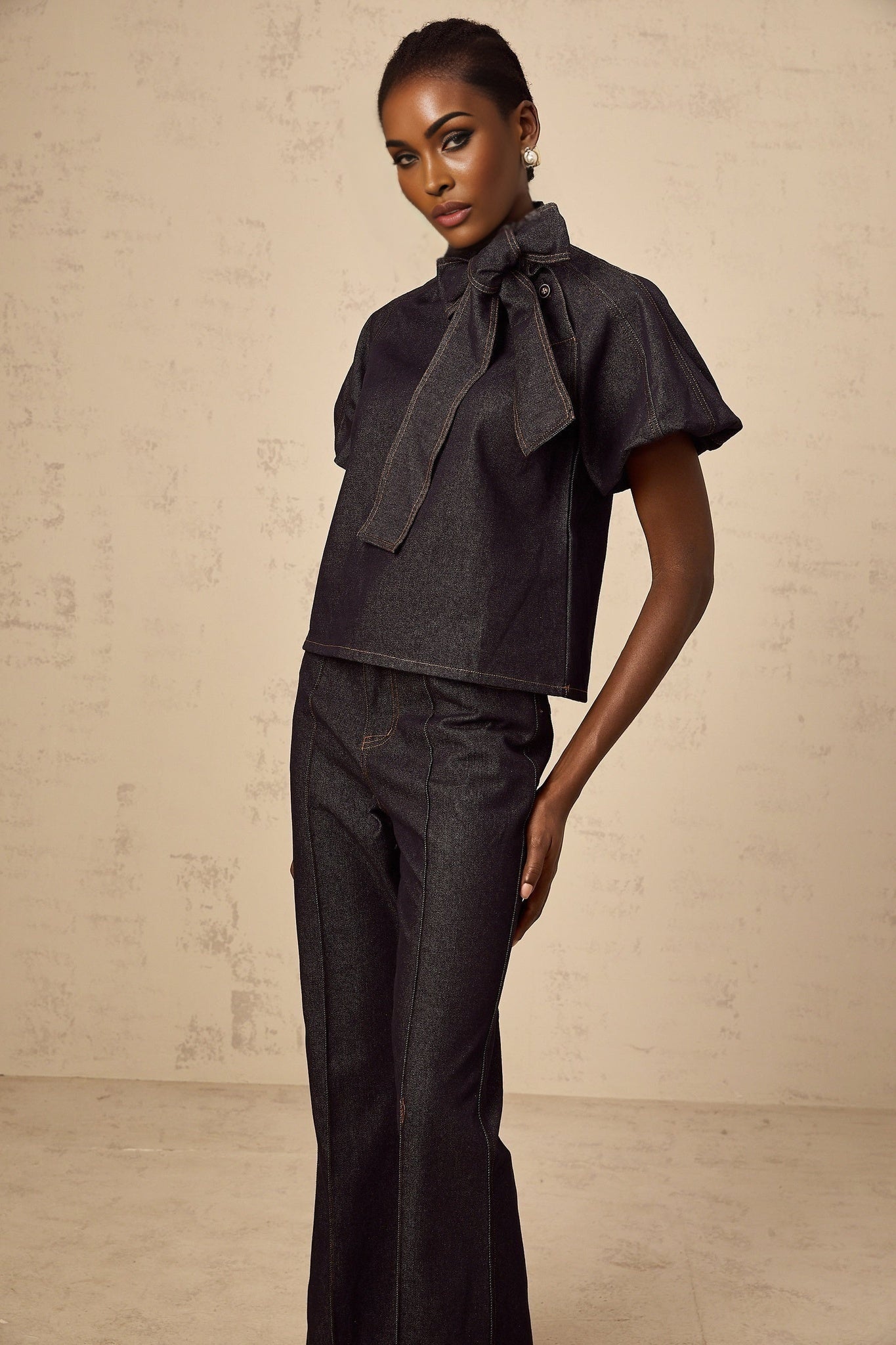 Woman wearing indigo blue denim blouse and jeans set with contrast stitching Roxane style matching outfit