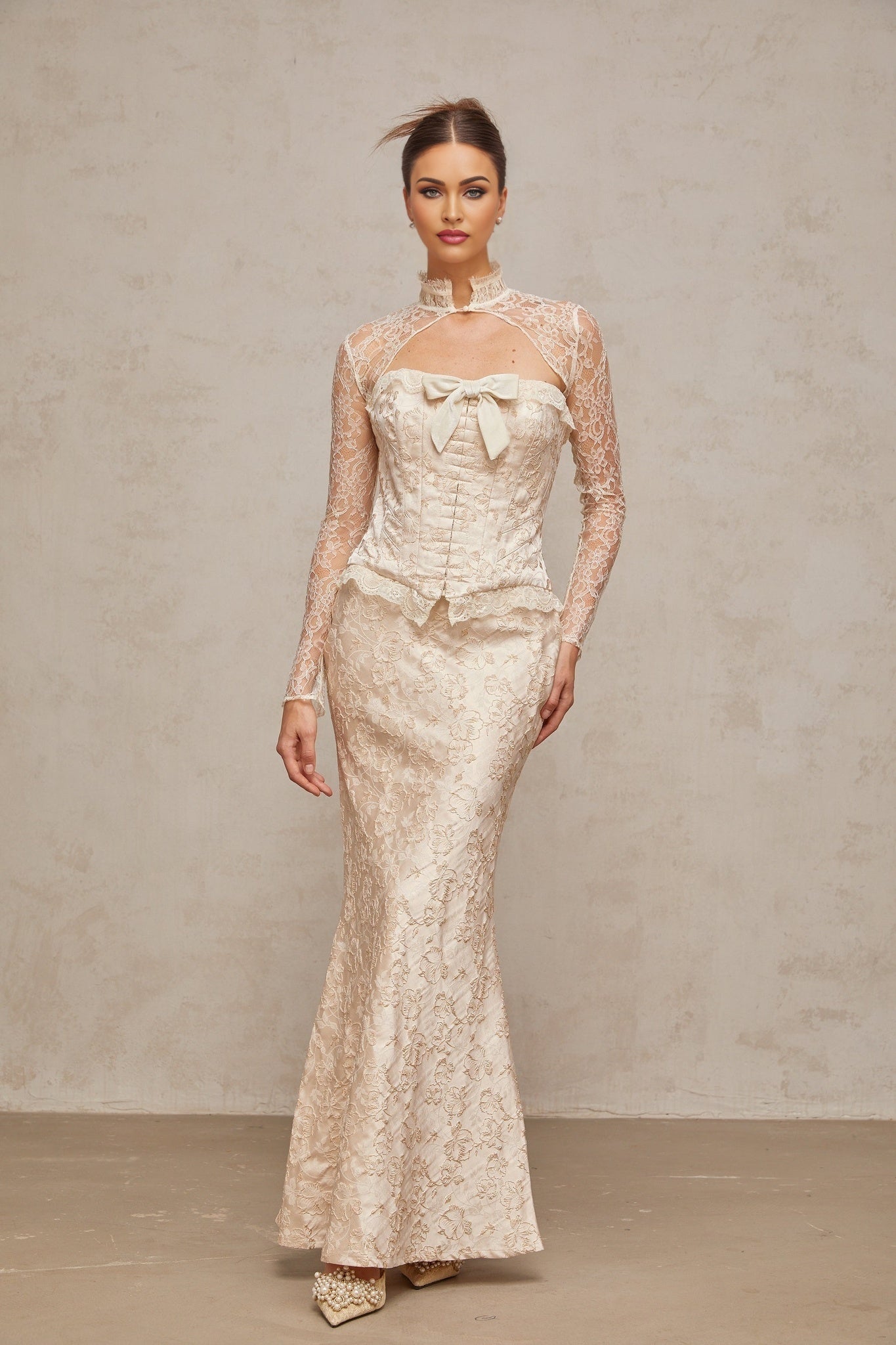 Woman wearing ivory matching set with top and skirt in patterned jacquard fabric