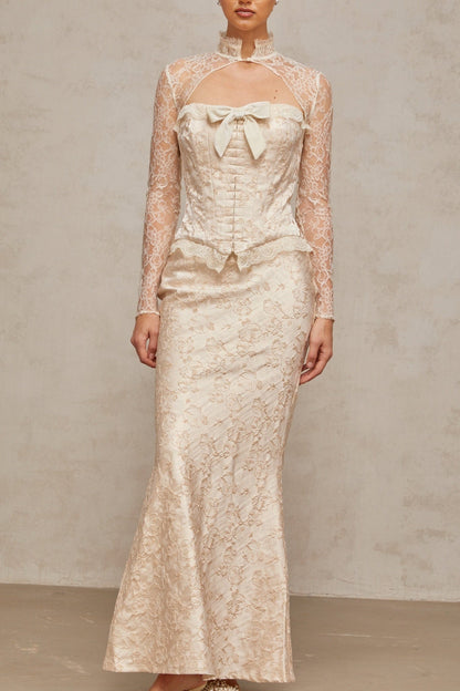 Woman wearing ivory two piece outfit with patterned jacquard fabric top and matching skirt